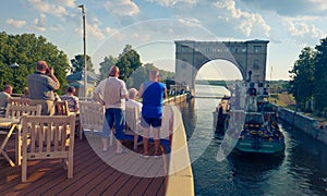 Cruise ship passengers take photos of water lock on the Volga River