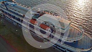 Cruise ship at the pier at sunset. Tourism. Aerial footage