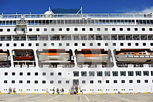 Cruise ship in port, passenger boarding