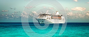 Cruise ship sailing on the Caribbean Sea. Side view of the vessel. Wide image.