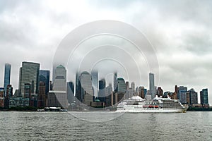 Cruise ship sailing next Manhattan in New York. Skyline of New York Manhattan cruising on the Hudson River cruise liner