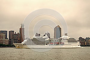 Cruise ship sailing next Manhattan in New York. Skyline of New York Manhattan cruising on the Hudson River cruise liner