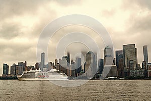 Cruise ship sailing next Manhattan in New York. Skyline of New York Manhattan cruising on the Hudson River cruise liner