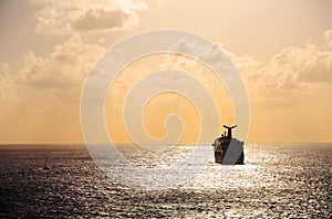 Cruise ship sailing into sunset