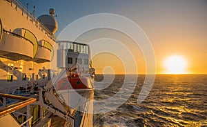 Cruise ship sailing in sunset on Atlantic Ocean