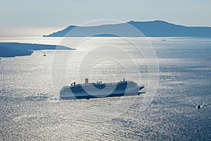 Cruise ship in Santorini/Greece with the volcanic island Thirasia in the background.