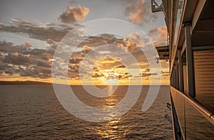 Cruise ship at sea with sun setting