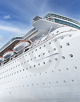 Cruise ship side view with blue sky. Vacation on ocean liner concept