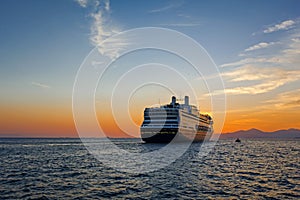 Cruise ship at sunset ready to depart