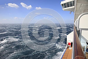 Cruise ship view from a balcony of rough seas and blue sky photo