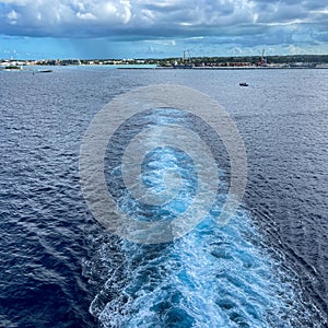 A Cruise ship wake on a beautiful stormy day with dark clouds and blue seas