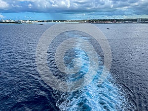 A Cruise ship wake on a beautiful stormy day with dark clouds and blue seas