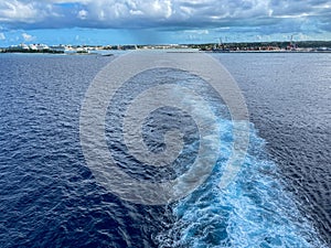 A Cruise ship wake on a beautiful stormy day with dark clouds and blue seas