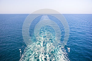 Cruise ship wake or trail on ocean surface, white trace