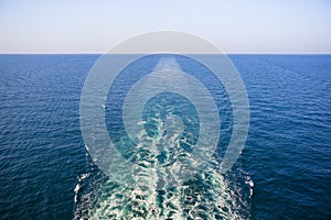 Cruise ship wake or trail on ocean surface, white trace