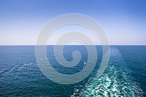 Cruise ship wake or trail on ocean surface, white trace