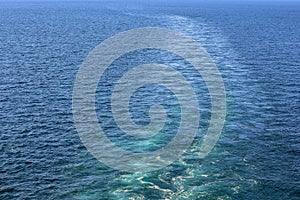 Cruise ship wake or trail on ocean surface, white trace