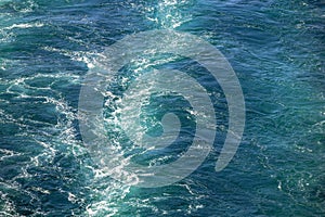 Cruise ship wake or trail on ocean surface, white trace