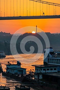 A cruise ship on the Yangtze River under the shining glow of the sunrise passes Cuntan Port