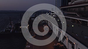 Cruise ships and cars at sea port at night.