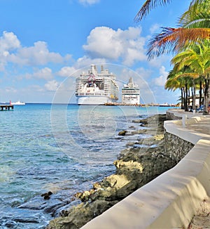 Cruise ships docked at a tropical island