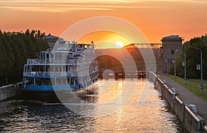 Cruise steamship passes through the gateway of the Moscow Canal at sunset