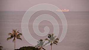 Cruise Summer vacation concept. Cruise ship far away in the sea near the tropical island at sunrise