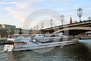 A cruise yasht of Radisson Royal sails under the Big Stone Bridge in Moscow