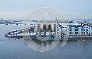 cruiser Aurora in St. Petersburg in snow and ice on the background of the city