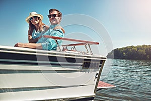 Cruising the beautiful waters with my beautiful wife. Portrait of a young couple spending time together on a yacht.