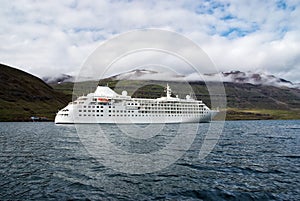 Cruising for pleasure. Cruise ship in sea on mountain landscape in Sejdisfjordur, Iceland. Ocean liner in sea with