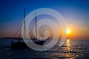 Cruising ship, sailing at sunset