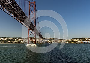 Cruising up the Tagus river and sailing under the bridge named after the 25th April revolution in Lisbon, Portugal