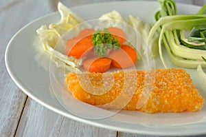 Crumbed fish fillet served on a plate photo