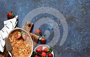 Crumble with strawberries on a benton background. View from above