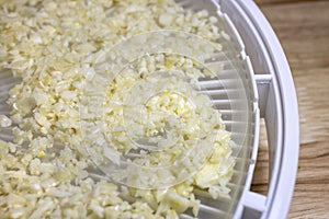 Crumbled Cauliflower laid on a dehydrating tray for food preservation