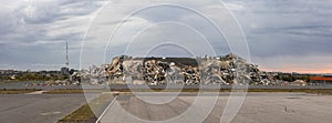 Crumbled concrete building with piles of debris. panoramic photo shot