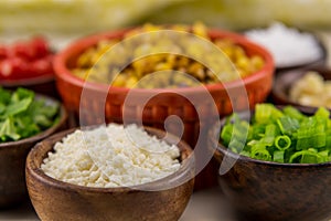 Crumbled Cotija Cheese in Wooden Bowl