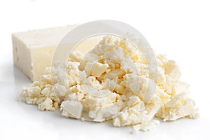 Crumbled white feta cheese isolated on white. photo