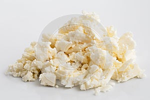 Crumbled white feta cheese on white.