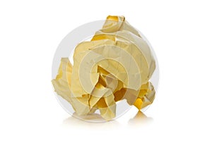 Crumbled yellow paper with linings ball on white background