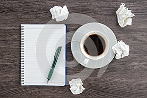 Crumple paper, notebook and pen with cup of coffee