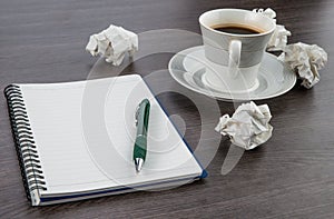 Crumple paper, notebook and pen with cup of coffee