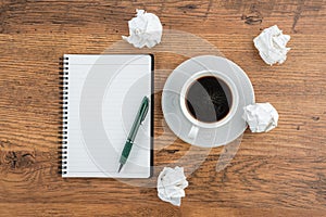 Crumple paper, notebook and pen with cup of coffee