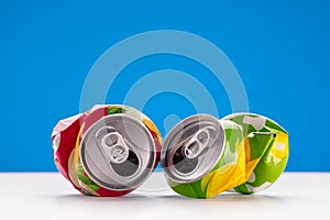 Crumpled aluminum can on a blue background. Recycling and recycling concept.