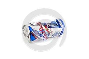 Crumpled aluminum can of RedBull drink over white background