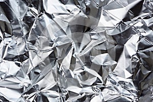 Crumpled Aluminum Foil with Folds and Creases as Background photo
