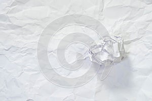 Crumpled ball on texture of white crumpled paper for background