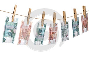 Crumpled banknote of roubles to dry on the rope clothes pins attached
