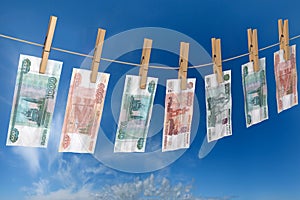 Crumpled banknote of roubles to dry on the rope clothes pins attached photo